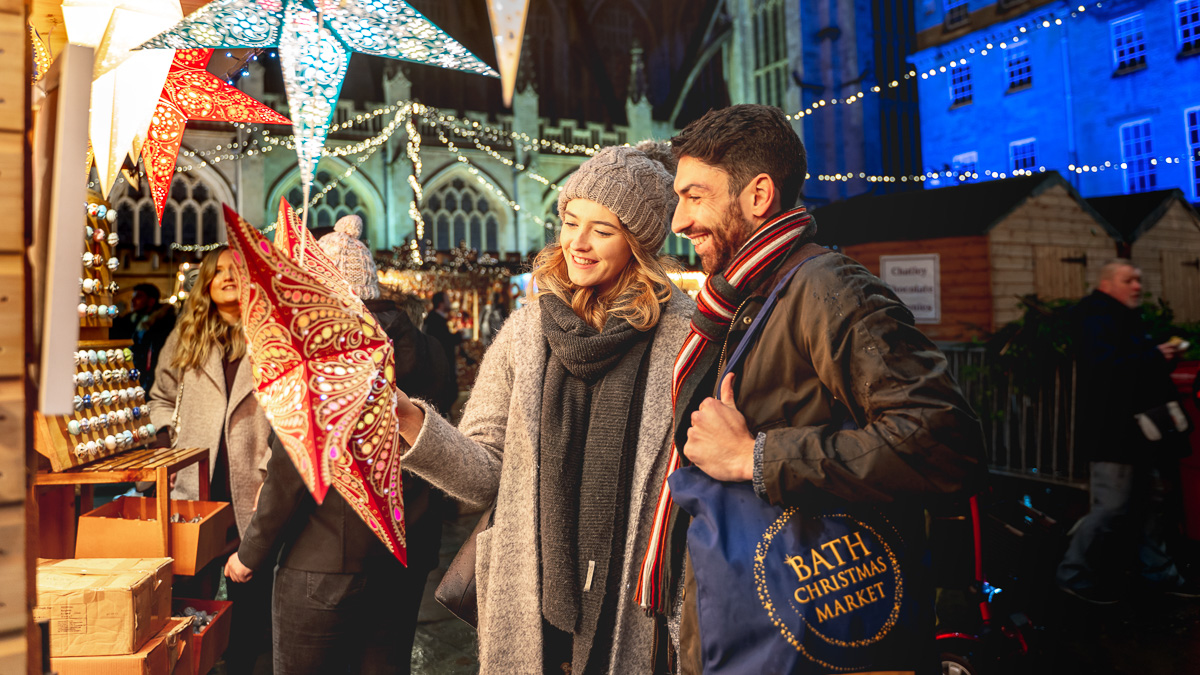 Visitors looking at stars, man with Bath Christmas Market Tote Bag